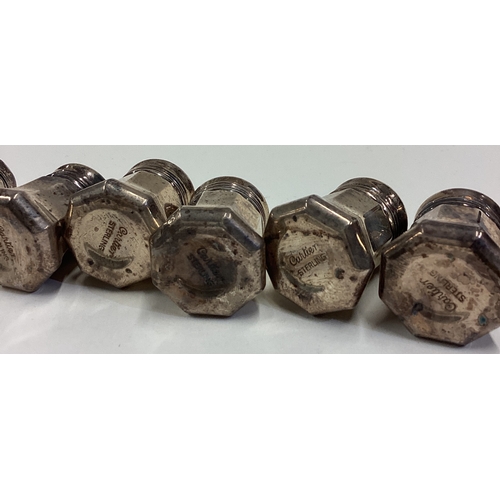 626 - CARTIER: A cased set of eight silver peppers. Approx. 80 grams of gross weight. Est. £100 - £150.