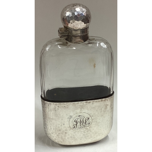 643 - A large silver mounted and glass flask. Apparently unmarked. Est. £120 - £150.