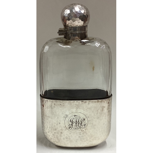 643 - A large silver mounted and glass flask. Apparently unmarked. Est. £120 - £150.