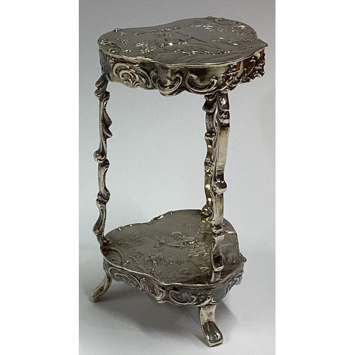 649 - A 19th Century Dutch silver toy two-tier occasional table embossed with figures bearing English impo... 