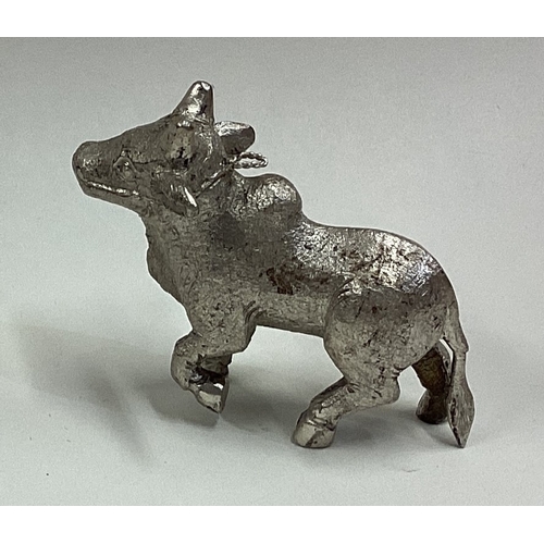 656 - A Chinese silver figure of a cow. Approx. 61 grams. Est. £60 - £80.