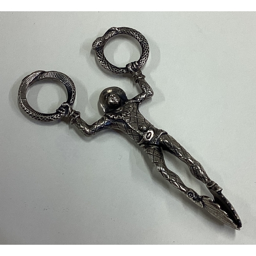 691 - A pair of 19th Century Georgian silver tongs in the form of a harlequin. Approx. 33 grams. Est. £60 ... 