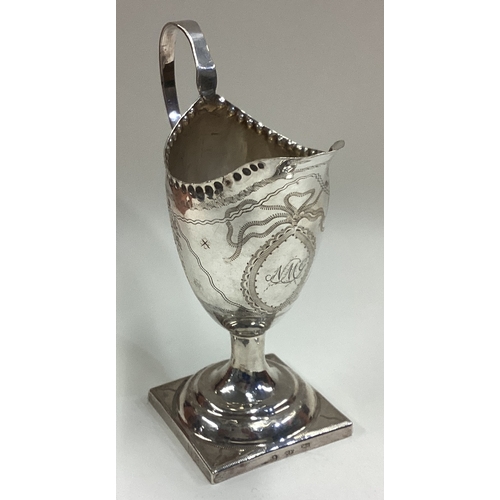 694 - A George III silver cream jug with bright-cut decoration. Circa 1790. Approx. 83 grams. Est. £60 - £... 