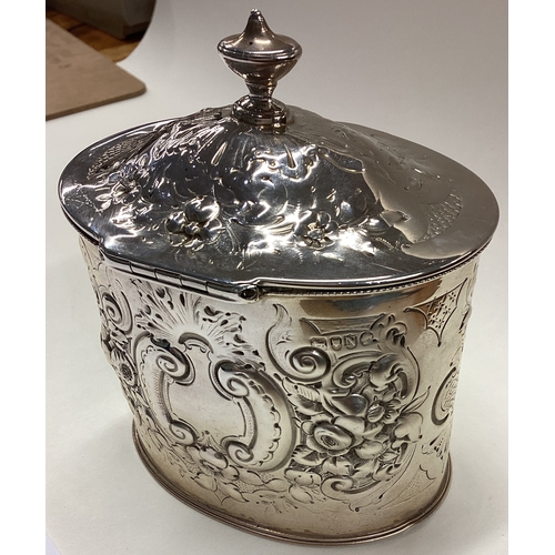 709 - A Victorian silver tea caddy with hinged cover embossed with floral decoration. London 1888. Approx.... 