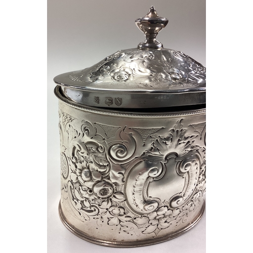 709 - A Victorian silver tea caddy with hinged cover embossed with floral decoration. London 1888. Approx.... 