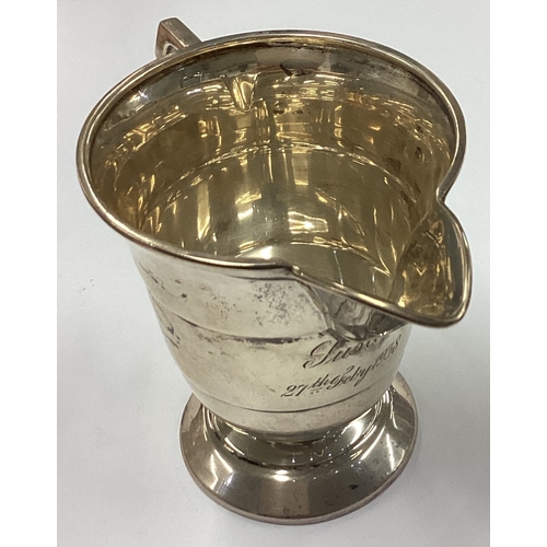 730 - A heavy Edwardian silver panelled cream jug. Birmingham. Approx. 105 grams. Est. £30 - £50.