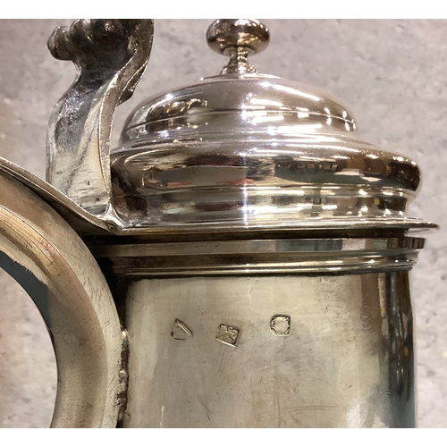 748 - A large George II silver flagon of plain cylindrical form, the domed hinged lid with knopped finial ... 