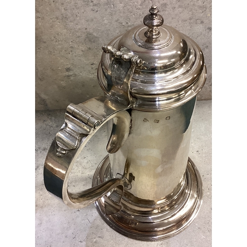 748 - A large George II silver flagon of plain cylindrical form, the domed hinged lid with knopped finial ... 