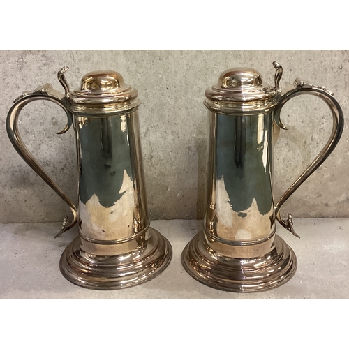 749 - A pair of George II silver flagons each of plain cylindrical form, with domed hinged lid, pierced an... 