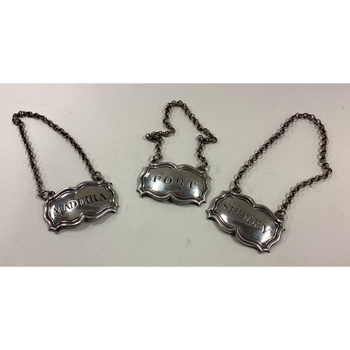 733 - A heavy set of three silver wine labels on suspension chains. London. By WS. Approx. 42 grams. Est. ... 