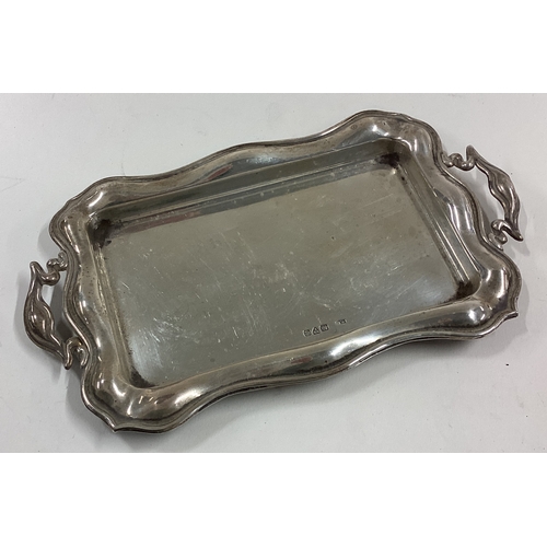 745 - A small silver dressing table tray of shaped form. Approx. 71 grams. Est. £60 - £80.