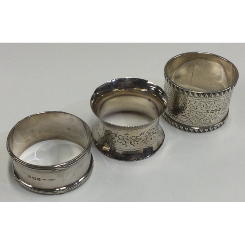 751 - A group of three silver napkin rings. Various dates and makers. Approx. 64 grams. Est. £20 - £30.