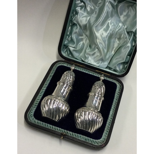 752 - A boxed pair of silver sugar casters. Sheffield. Approx. 131 grams. Est. £150 - £200.