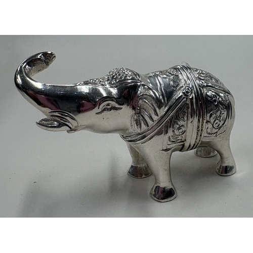 107 - A heavy cast silver figure of an elephant. Approx. 132 grams. Est. £120 - £150.