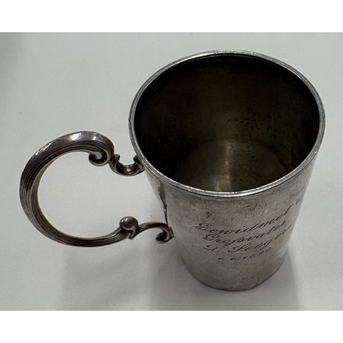 124 - An Antique Continental silver mug with engraved decoration. Marked to base. Approx. 47 grams. Est. £... 