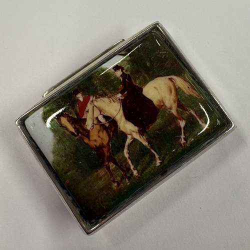 129 - A silver and enamelled pill box depicting horse riding scenes. Approx. 26 grams. Est. £20 - £30.