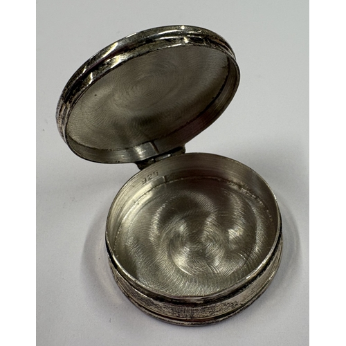 131 - A novelty Sterling silver pill box with engraved decoration. Approx. 13 grams. Est. £20 - £30.