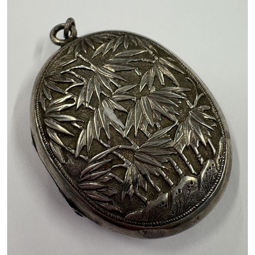 142 - A rare 19th Century Chinese export silver locket chased with figures and foliage. Circa 1860. Approx... 