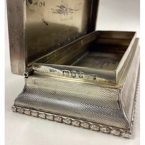 145 - A large silver combination snuff box with gold plaque to centre and striker to side. London 1919. By... 