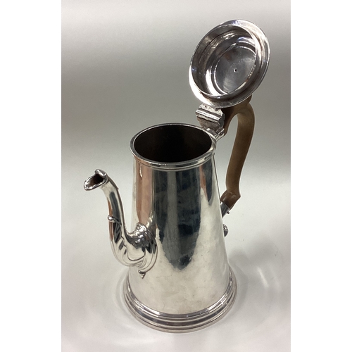 148 - A large and impressive 18th Century George II silver coffee pot decorated with hand crest. Fully mar... 