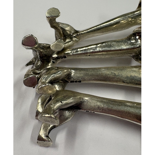 161 - A set of four silver knife rests in the form of dogs. London 1997. By Nat Leslie Ltd. Approx. 87 gra... 