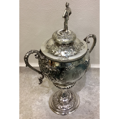 189 - A large and impressive chased Victorian silver cup and cover with figural finial presented by 'Shaw ... 