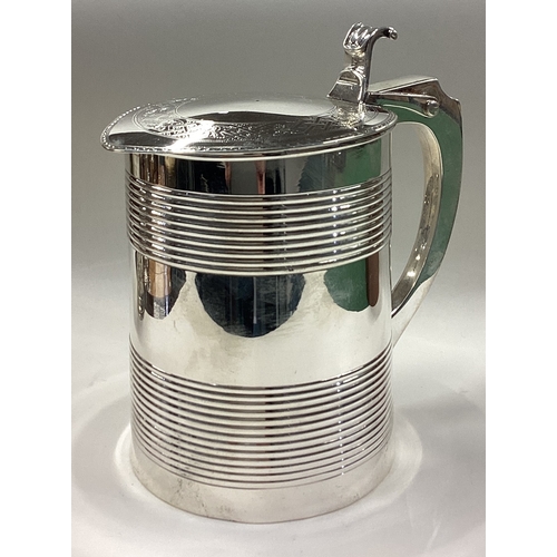 219 - A heavy 18th Century George III silver lidded tankard. Fully marked to body and cover. London 1776. ... 