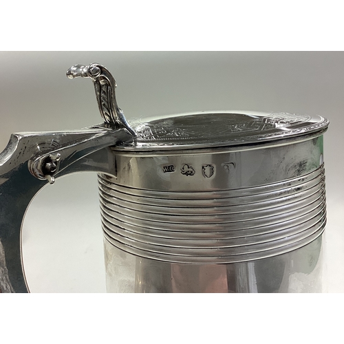 219 - A heavy 18th Century George III silver lidded tankard. Fully marked to body and cover. London 1776. ... 