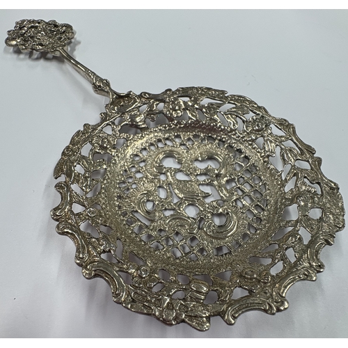 22 - A pierced Victorian silver serving spoon with embossed decoration. Birmingham 1890. By D&S. Approx. ... 