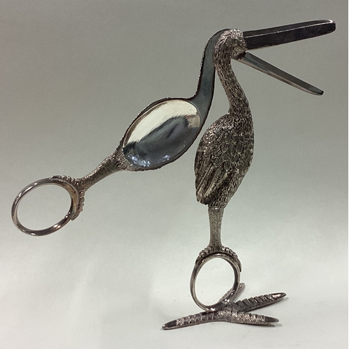 221 - A large pair of novelty white metal grape scissors in the form of a bird on stand. Est. £80 - £120.