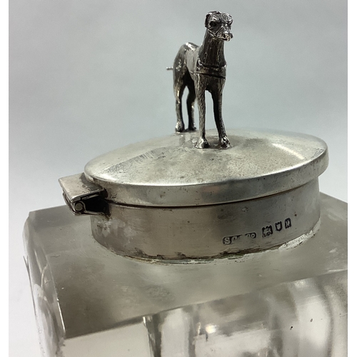 238 - A novelty silver mounted glass inkwell cast with greyhound. London 1925. Est. £100 - £150.