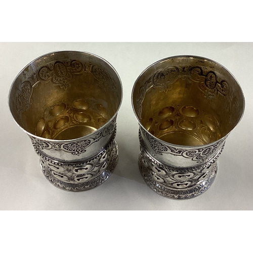 243 - A pair of Continental silver beakers. Approx. 314 grams. Est. £300 - £400.