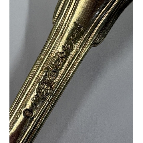 252 - An 18th Century French silver gilt fork with crested decoration. Approx. 62 grams. Est. £60 - £80.