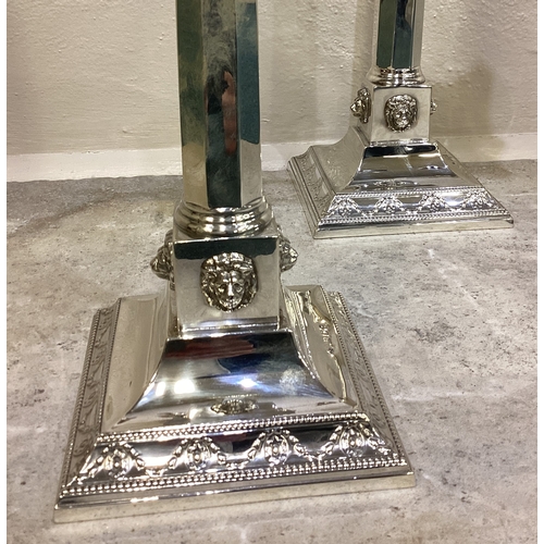 269 - A fine pair of Judaica silver candelabras of classical design chased with lion decoration. London 19... 