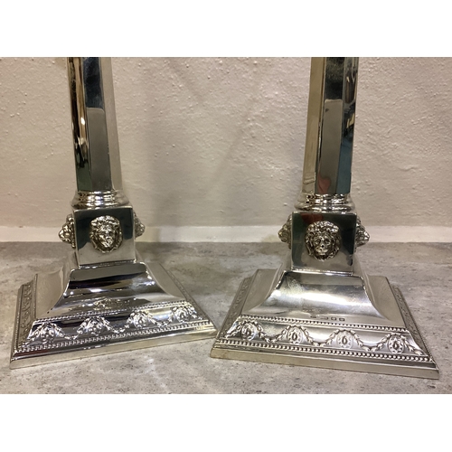 269 - A fine pair of Judaica silver candelabras of classical design chased with lion decoration. London 19... 