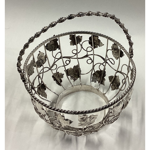 275 - An 18th Century George III silver swing-handled basket with grape and vine decoration. London 1769. ... 