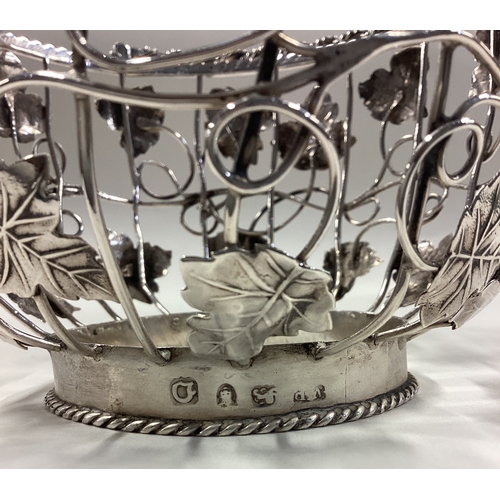 275 - An 18th Century George III silver swing-handled basket with grape and vine decoration. London 1769. ... 