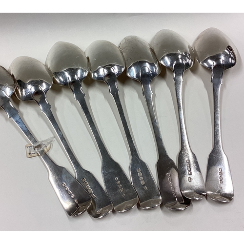 304 - A matched set of seven large silver fiddle pattern dessert spoons. Various dates and makers. Approx.... 