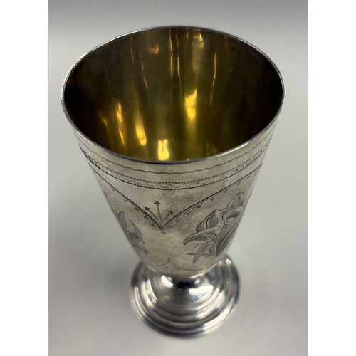 317 - A Victorian silver goblet with engraved floral panels. London 1875. By Henry Holland. Approx. 160 gr... 