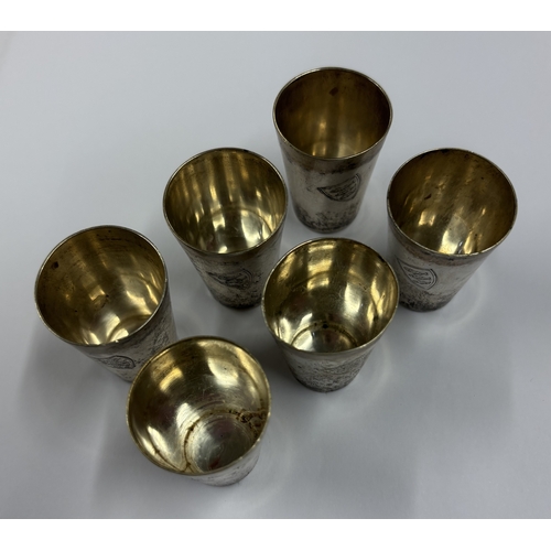 347 - A set of six Continental silver stacking beakers decorated with fish coat of arms. Approx. 99 grams.... 