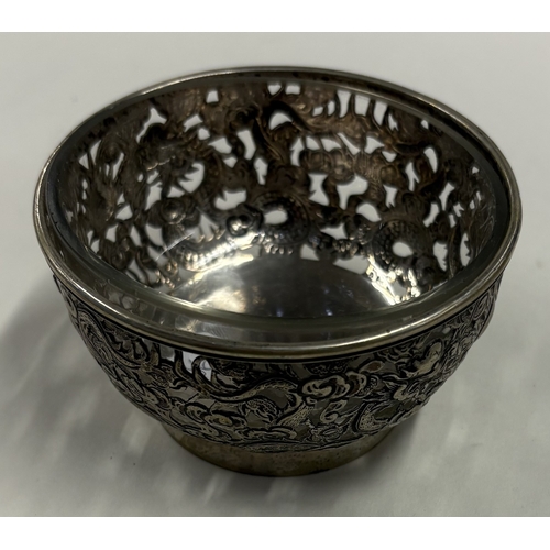 362 - A Chinese export silver bowl pierced with dragon decoration together with glass liner. Character mar... 