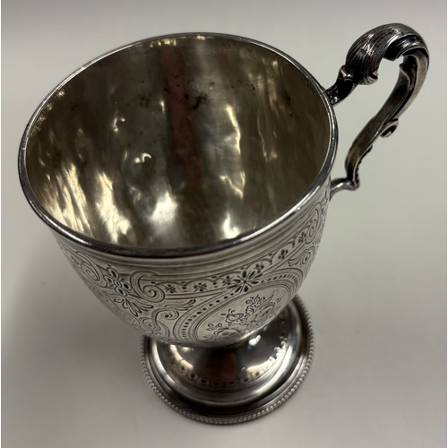 363 - A Victorian silver panelled mug with engraved decoration. London 1869. By William Eley. Approx. 156 ... 