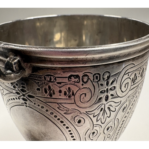 363 - A Victorian silver panelled mug with engraved decoration. London 1869. By William Eley. Approx. 156 ... 