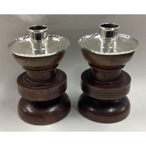 369 - A pair of silver mounted wood candlesticks. London 1913. By FJR. Approx. 550 grams of gross weight. ... 