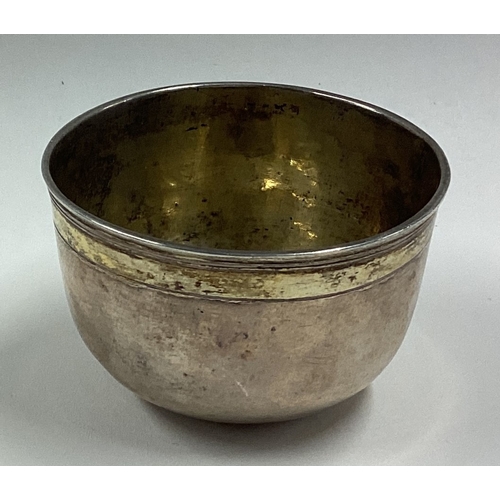 387 - A crested 17th Century silver beaker. Dated 1691. Approx. 44 grams. Est. £200 - £300.