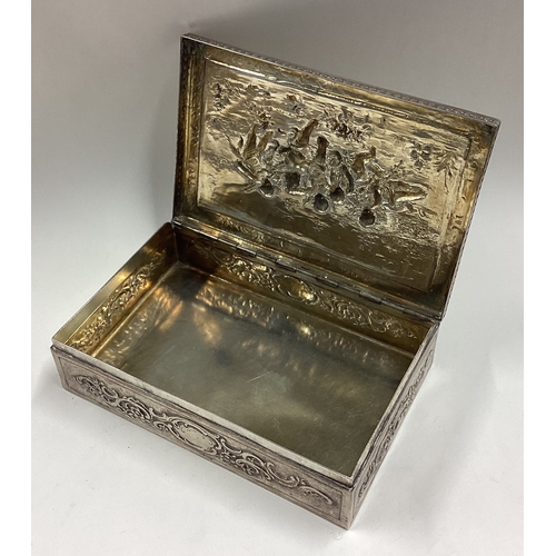 404 - An embossed Continental silver cigar box with hinged cover chased with figures. Marked to base. Appr... 