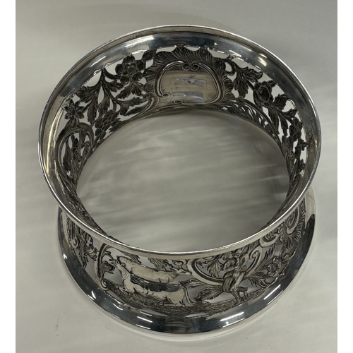 410 - DUBLIN: An Irish silver dish ring pierced with swans, cows and Chinoiserie decoration. 1915. By Wake... 