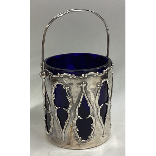 521 - A stylish silver sugar basket with scroll decoration together with BGL. Birmingham. By WHS. Approx. ... 