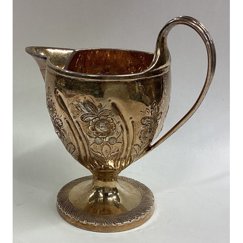 529 - A good quality Georgian silver gilt cream jug with floral decoration. London. Approx. 138 grams. Est... 