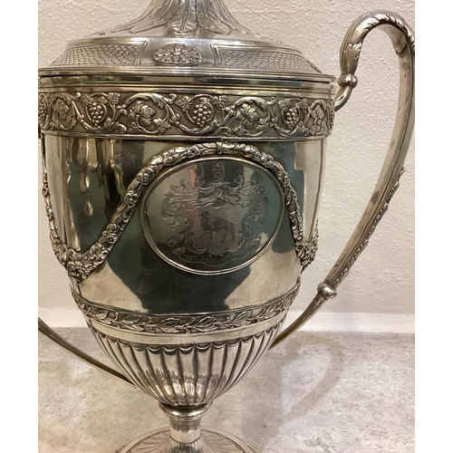 55 - A large and impressive 19th Century George III silver trophy cup and cover embossed with vines, foli... 